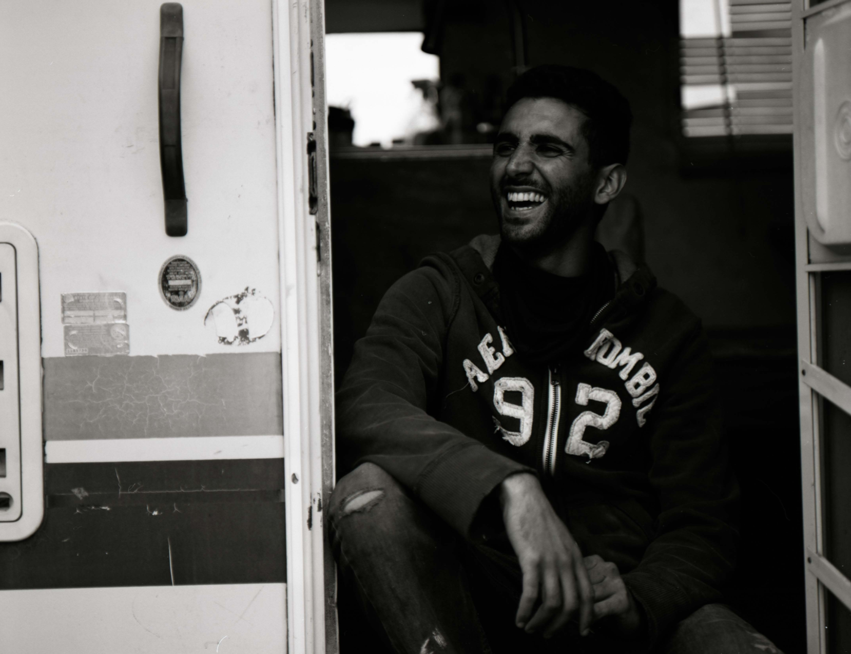 Man sitting in the doorway of his RV