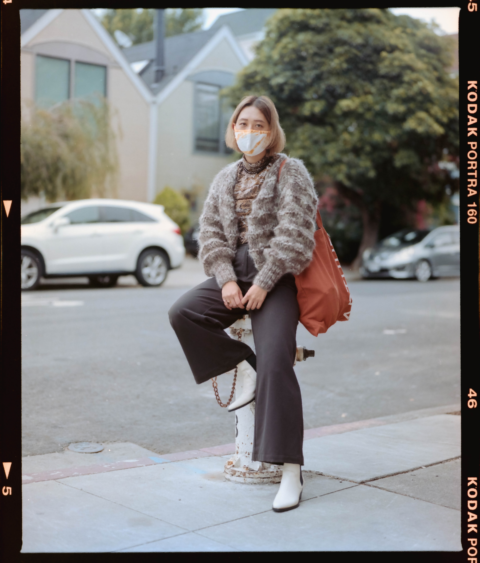 Photograph of Connie in the Lower Haight leaning against a fire hydrant with one leg up