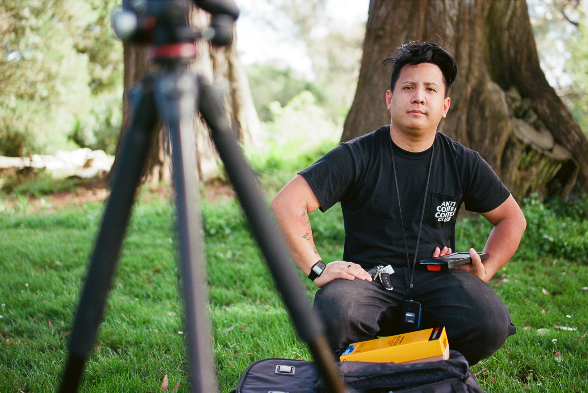 JP Calma squats down next to his large-format Graflex Speed Graphic camera in Golden Gate Park