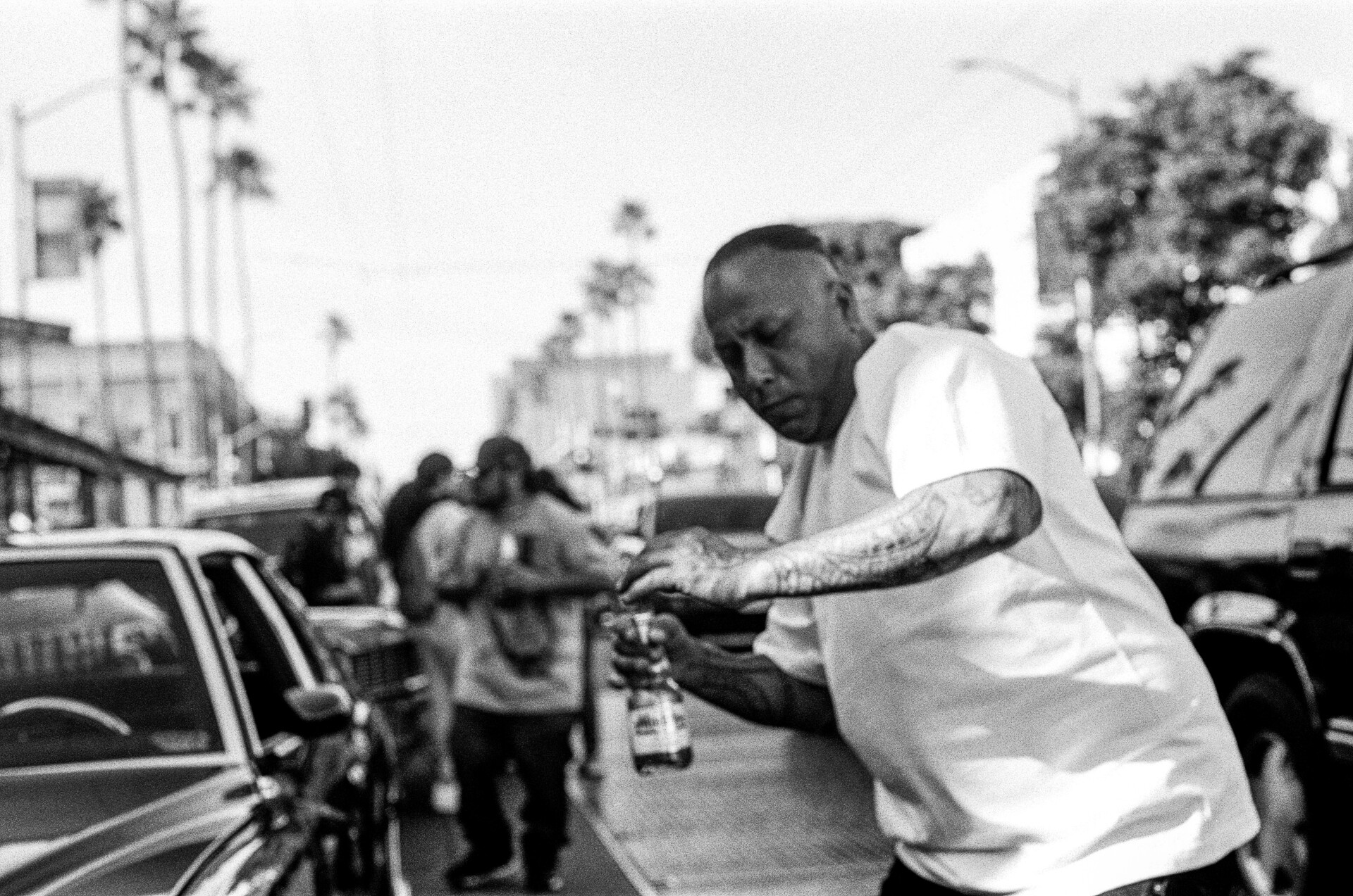 A man, beer in hand, dances on the Mission Street sidewalk