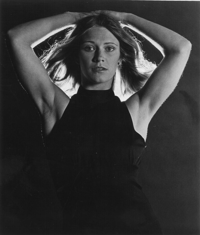 Chambers, arms in the air behind her head, models for a promotional photo for Behind the Green Door, the 1972 film that made her a star.